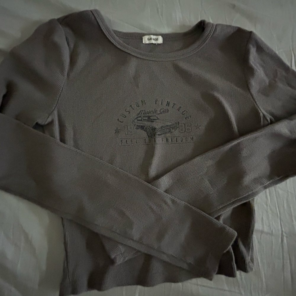 This is a graphic long sleeve from Garage. It is barely worn.